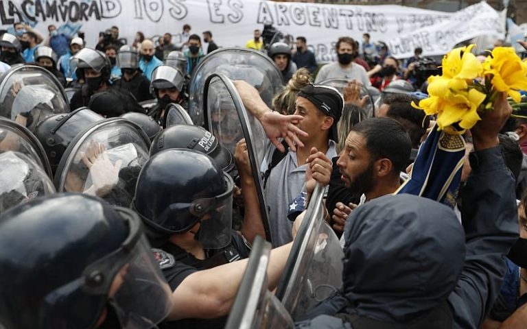 Violence erupts as police clash with tearful fans at Maradona’s wake