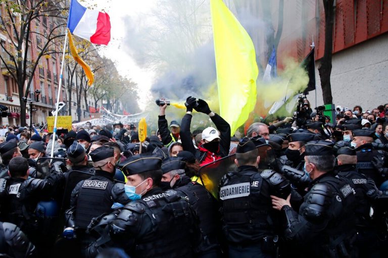 Protesters storm Paris streets to denounce police brutality, tear gas fired