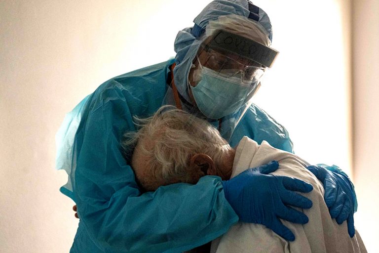 Photo of Texas doctor comforting elderly Covid patient goes viral