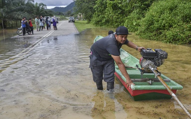Villagers go by boat rides after bridge is flooded