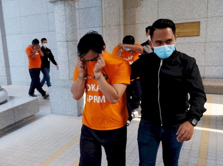 Three more remanded for six days over sale of foreign workers’ work-pass stickers, govt revenue stamps