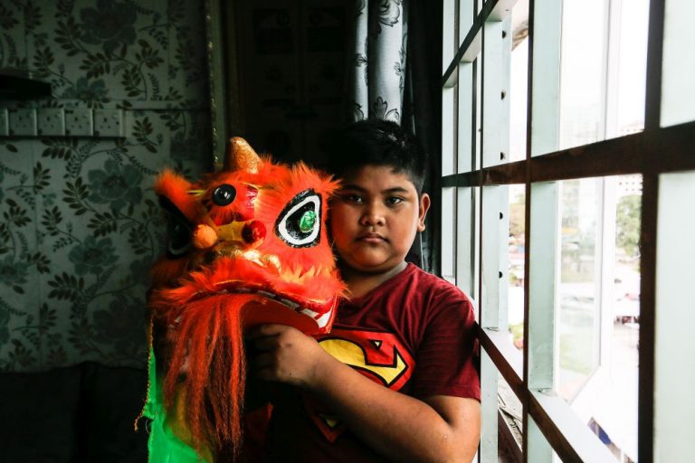 No lion dances this CNY? Well, this Malay boy is not going to stop practising his lion dance routine