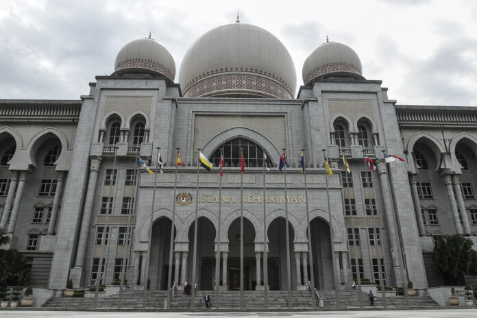 In court, woman born in Pahang to Muslim refugee parents from Cambodia bids to join siblings as Malaysian