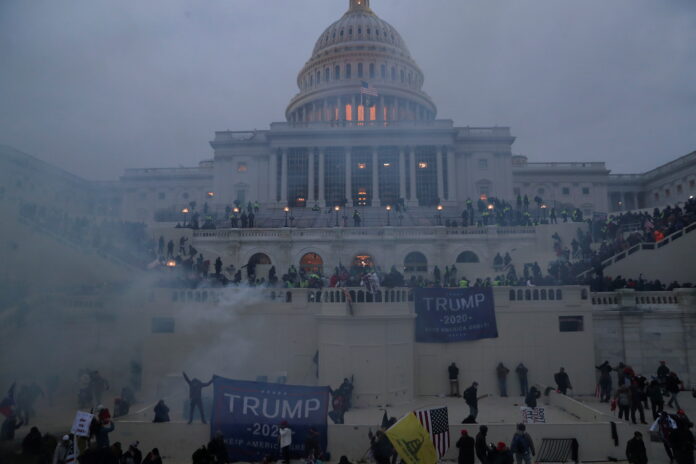 A year after Capitol riot, Americans fear for their democracy, say polls