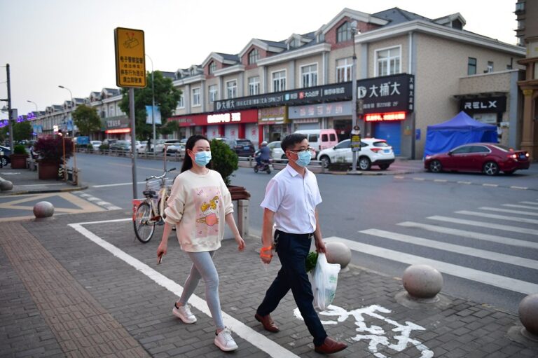 Shanghai lets some residents leave home, cautiously eases Covid curbs
