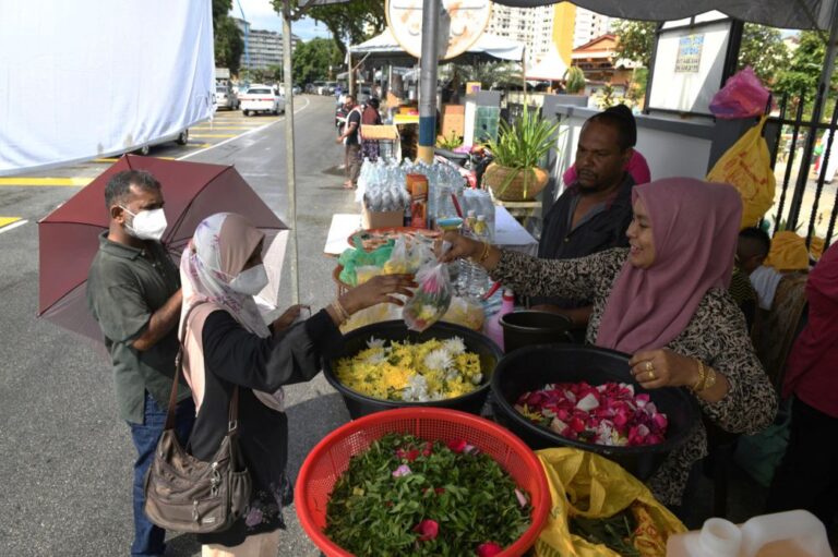 At Muslim cemetery in Penang, brisk business for flower traders during Raya
