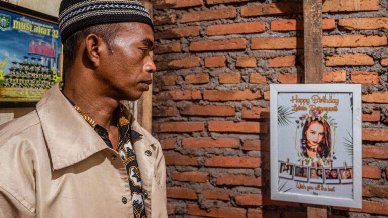 At Indonesia cemetery, father kisses daughter killed in stadium crush goodbye