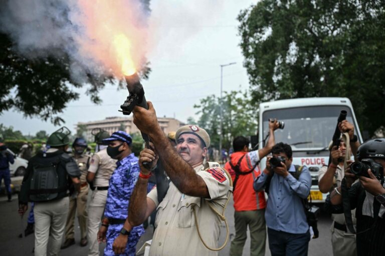 Indian police fire tear gas as thousands of protesters demand action over exam leaks
