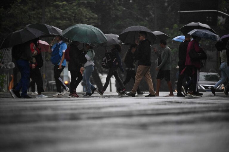 Umbrellas replace beach towels as Rio endures record-wet September